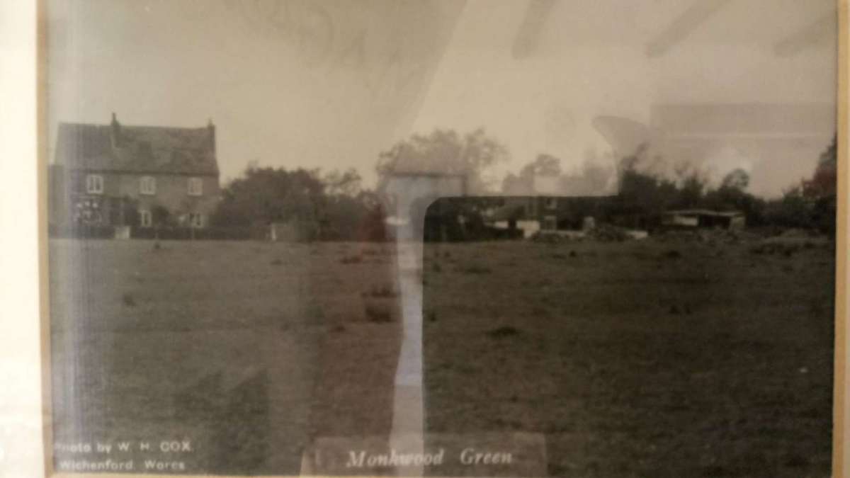 A black and white photo of Monkwood Green Common, showing the houses approx 100 years ago